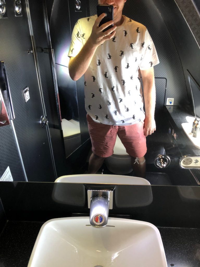 a man taking a selfie in a bathroom