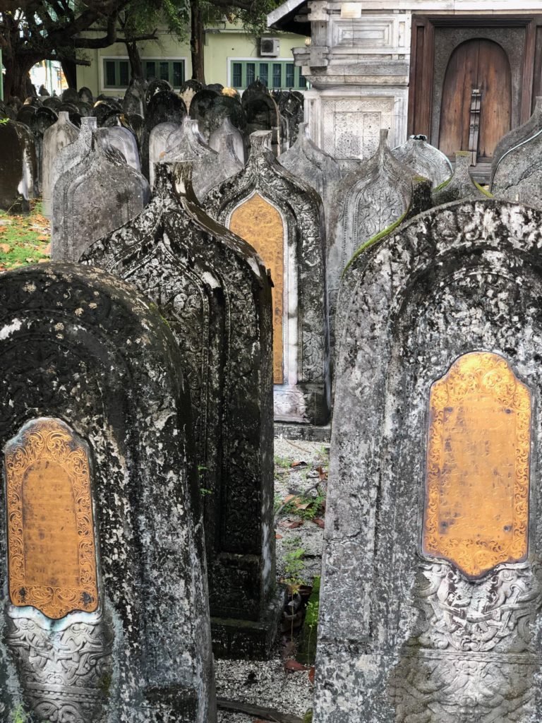 a group of headstones in a cemetery