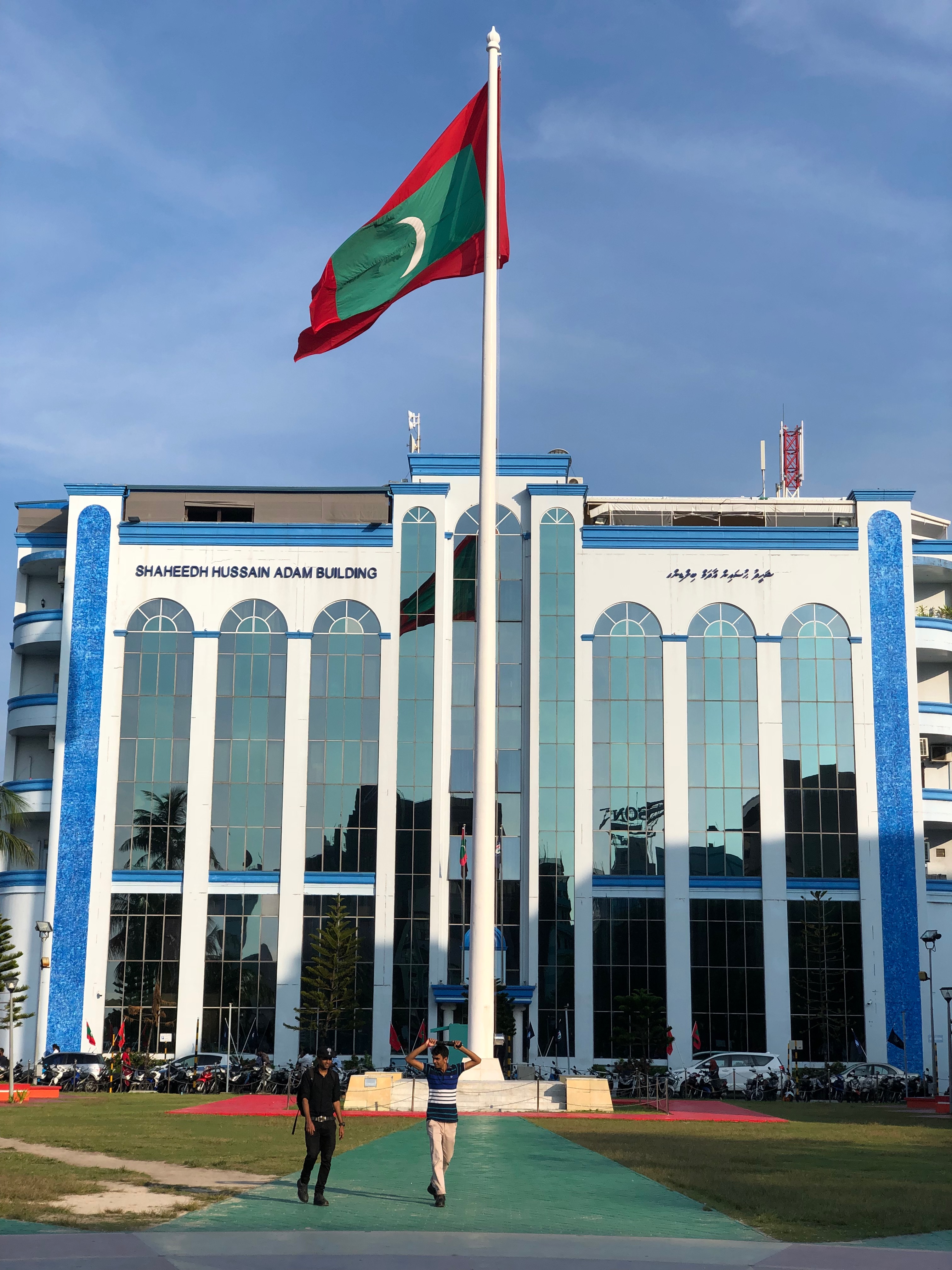 a flag on a pole in front of a building