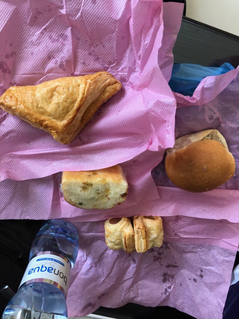 a group of pastries on a pink paper