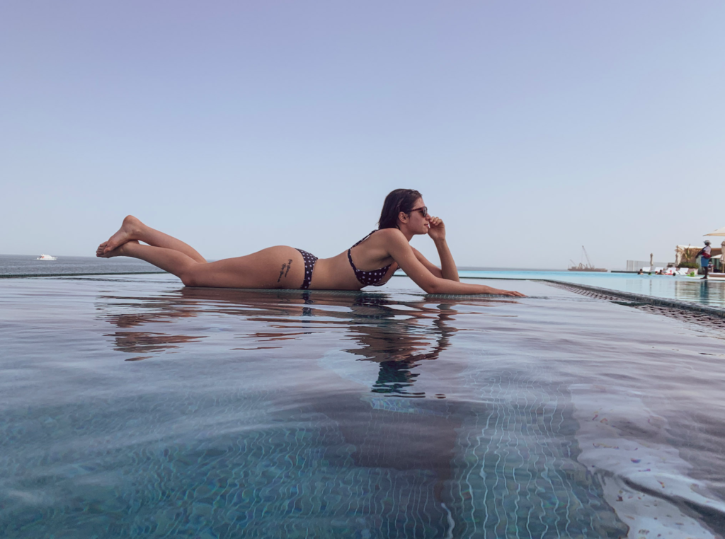 a woman lying on a pool edge