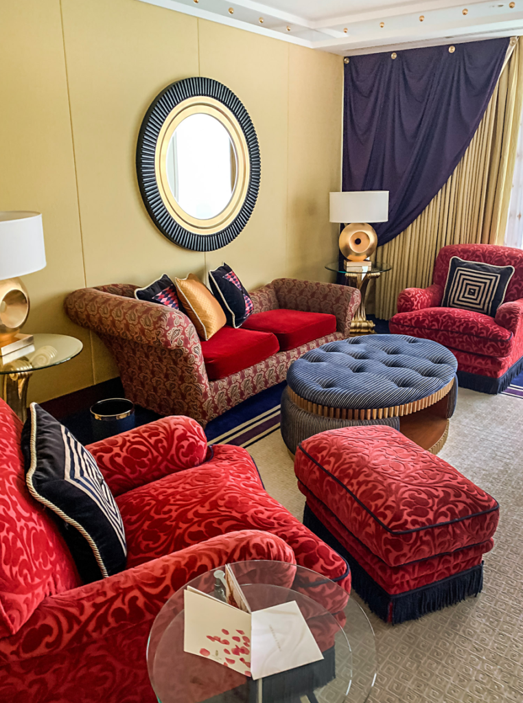 a room with red couches and chairs