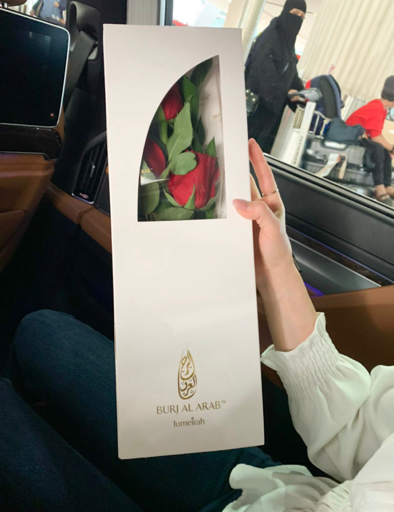 a person holding a box with flowers inside