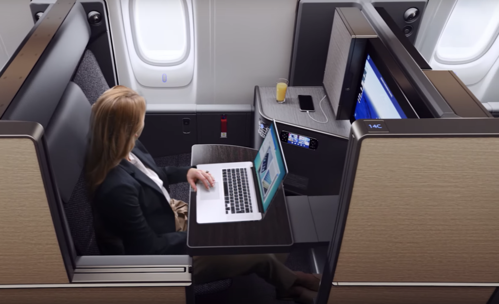 a woman sitting at a table with a laptop