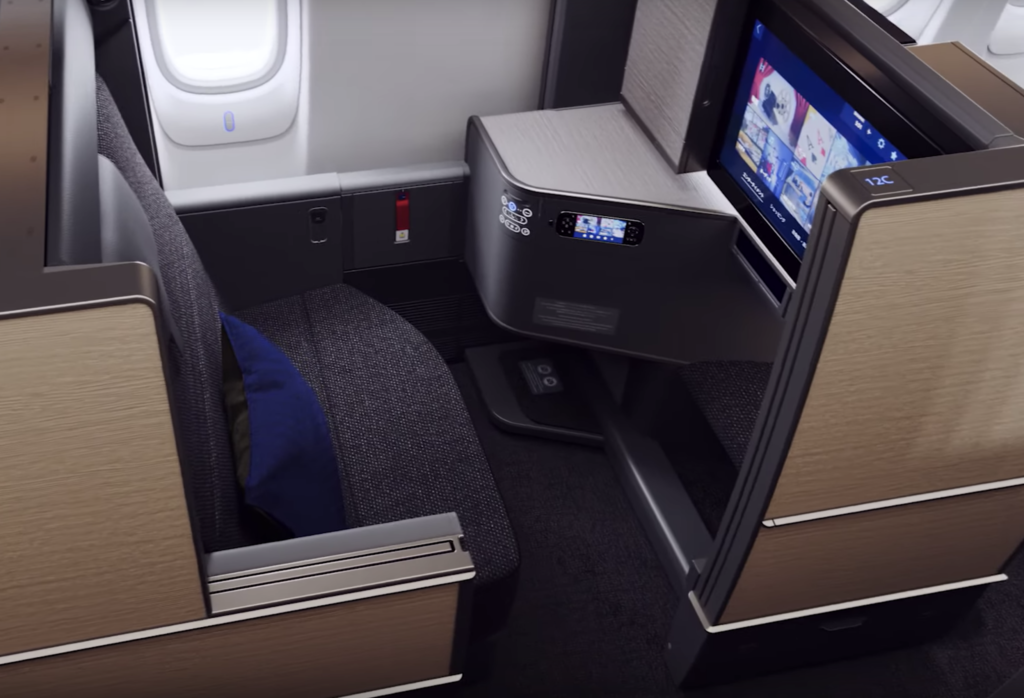 a seat and a tv in an airplane