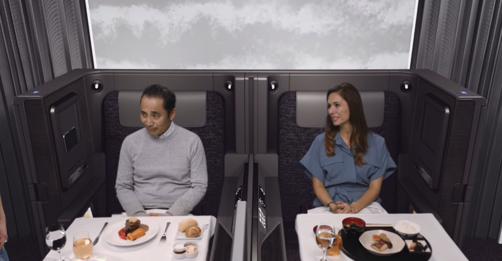 a man and woman sitting at tables with food on them