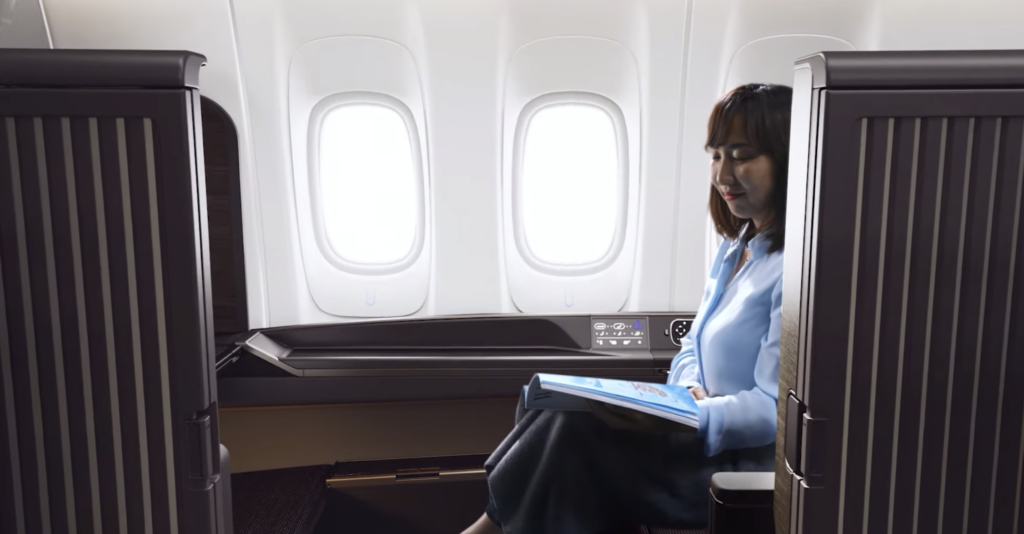 a woman reading a book on an airplane