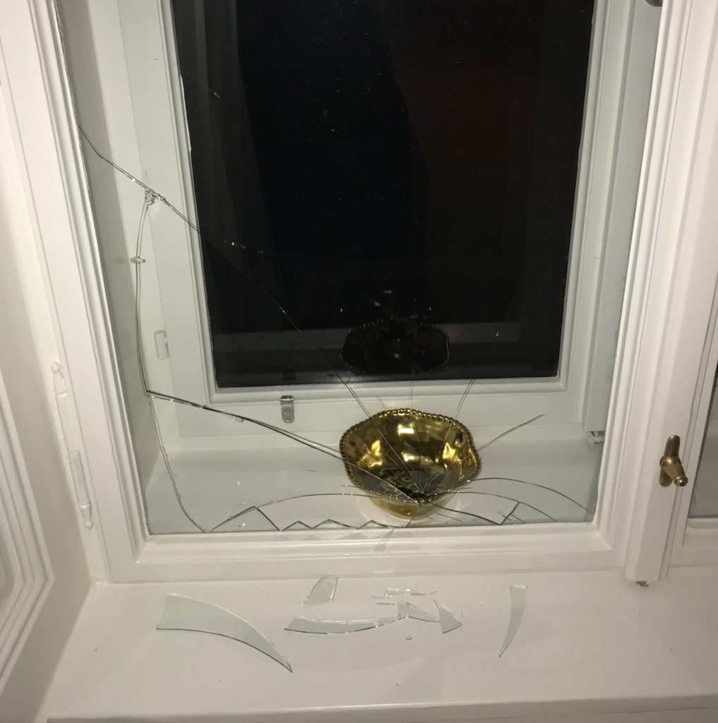 a broken window with a bowl on it