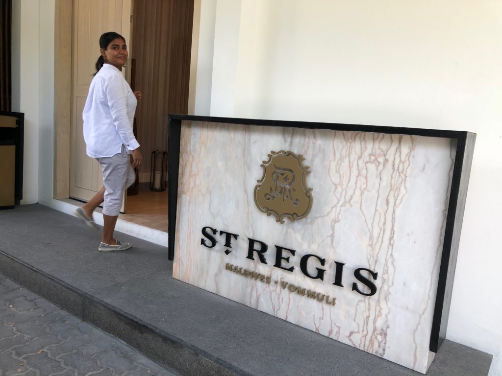 a woman walking next to a sign