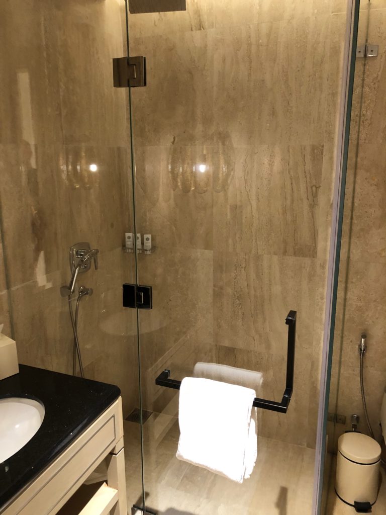 a bathroom with a glass shower door