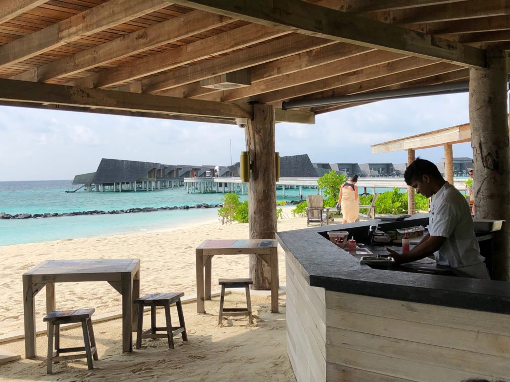 a man working at a bar on a beach