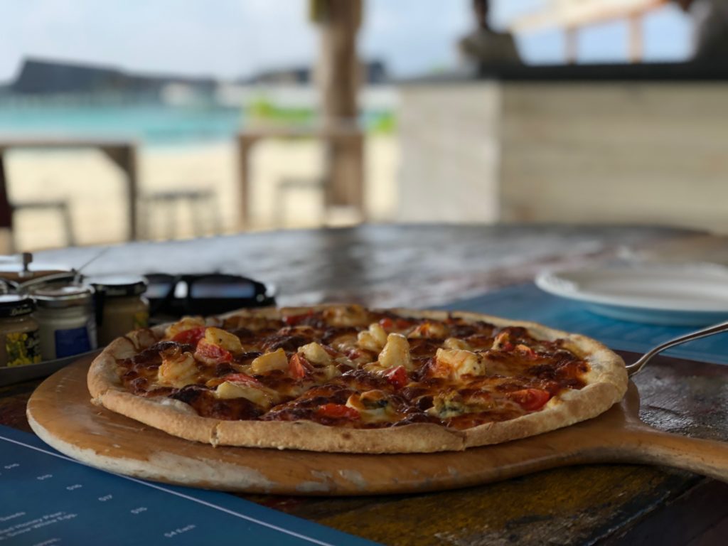 a pizza on a wooden board