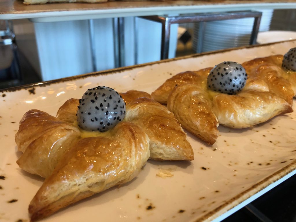 a plate of pastries with a speckled egg on top