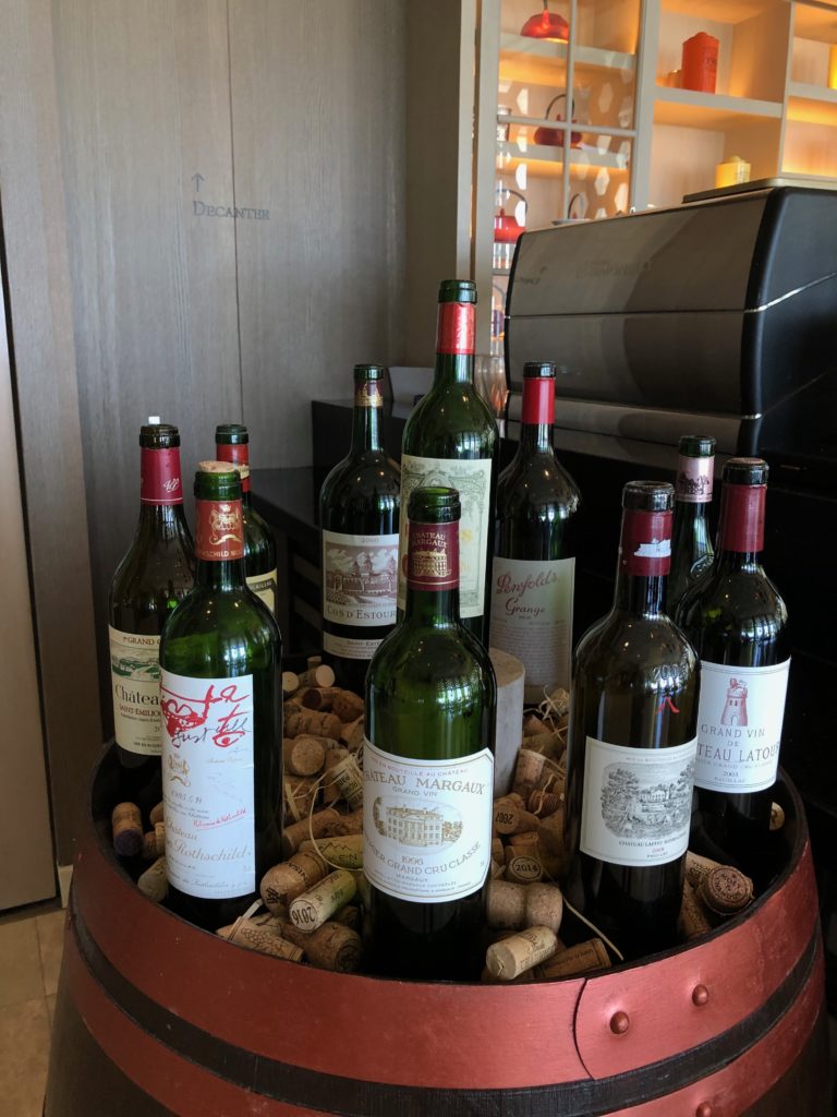 a group of wine bottles on a barrel