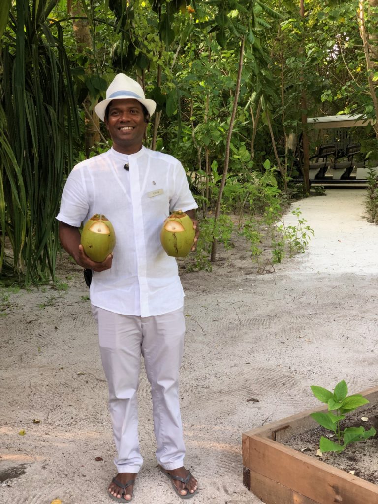 a man holding two coconuts