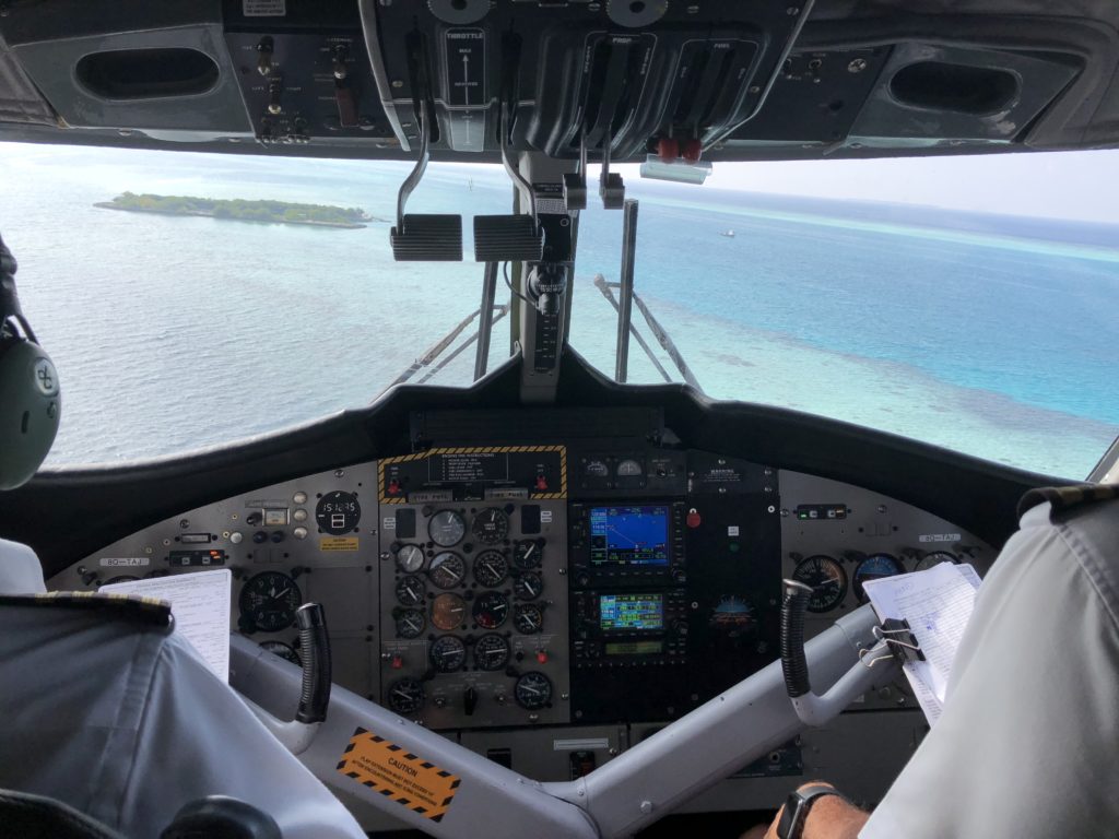 a cockpit of a plane with a view of the ocean