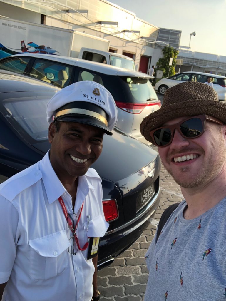 a man in a hat and sunglasses taking a selfie with another man in a hat and sunglasses