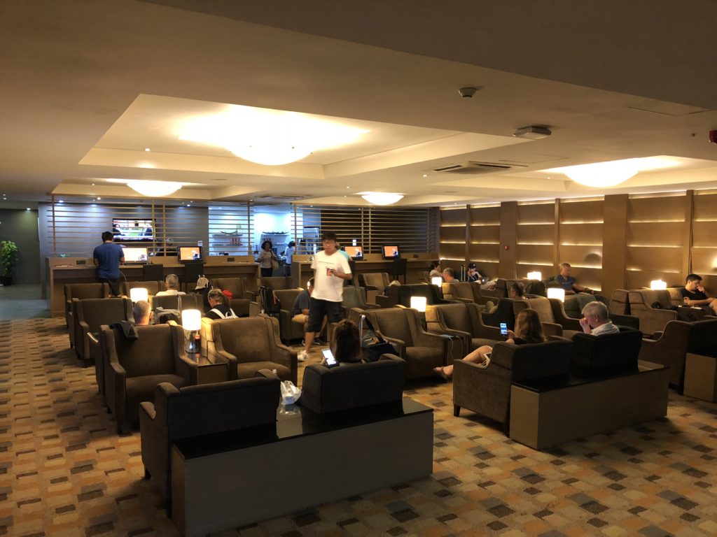 a group of people sitting in a room with computers