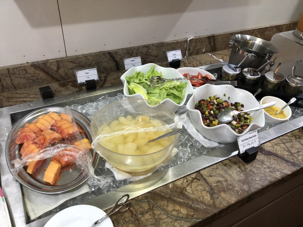 a buffet line with different food items on it