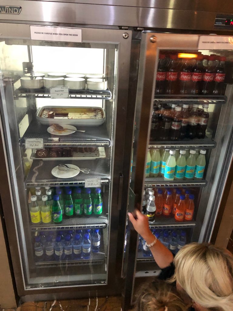 a woman looking at a refrigerator