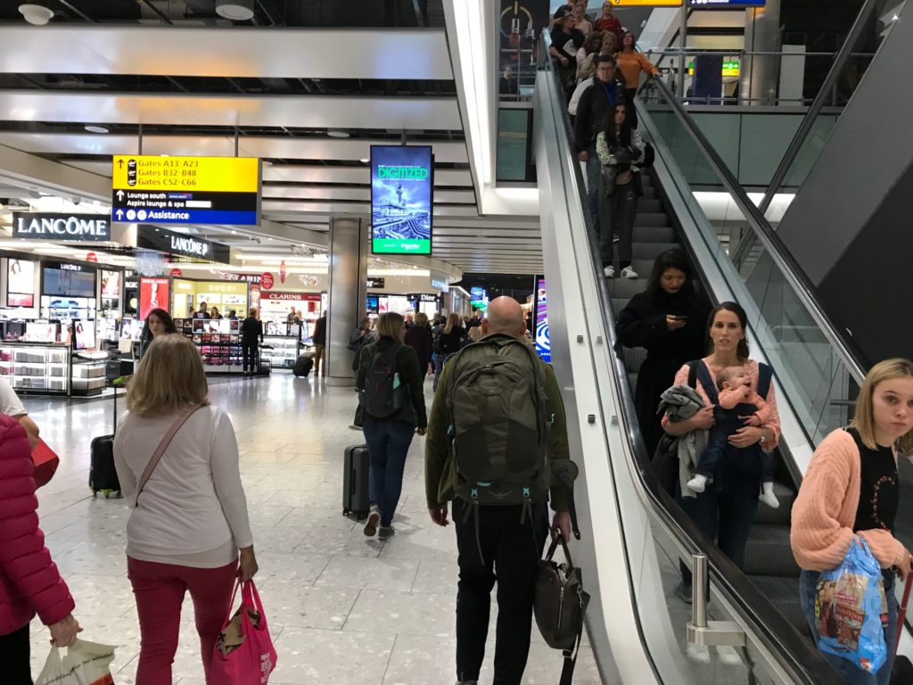 people on an escalator in a airport