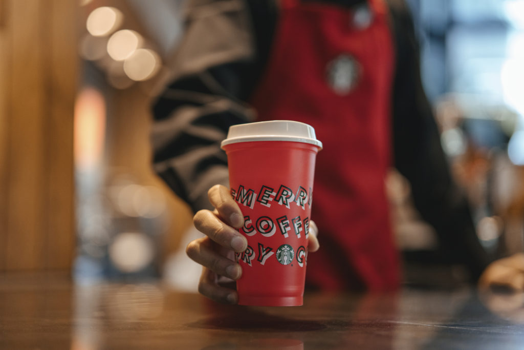 a person holding a red cup