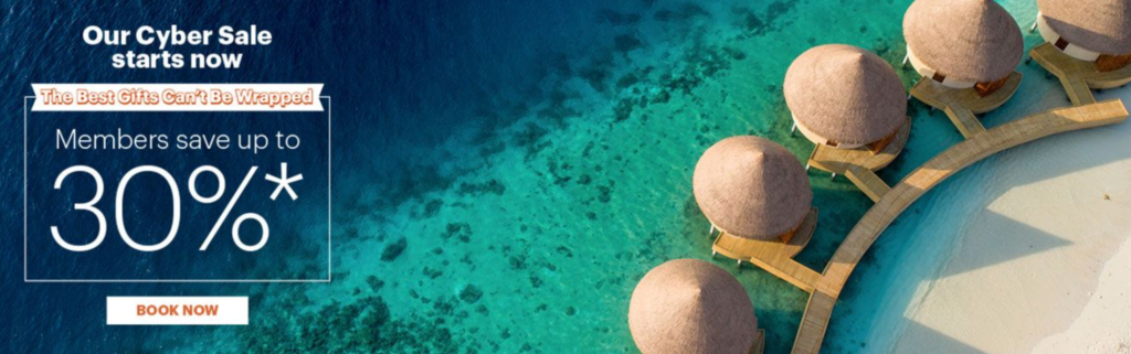 a group of straw umbrellas on a beach