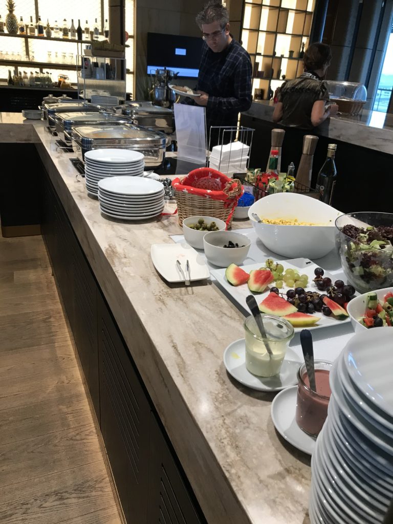 a buffet line with plates and food on it