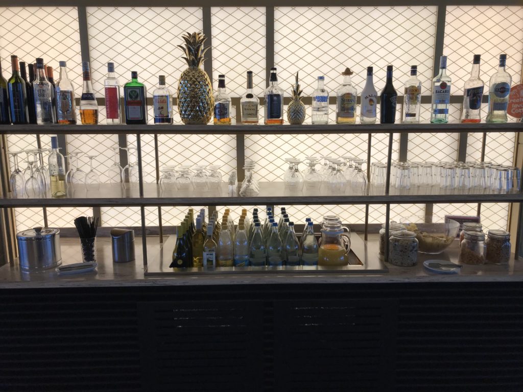 a shelf with bottles and glasses on it