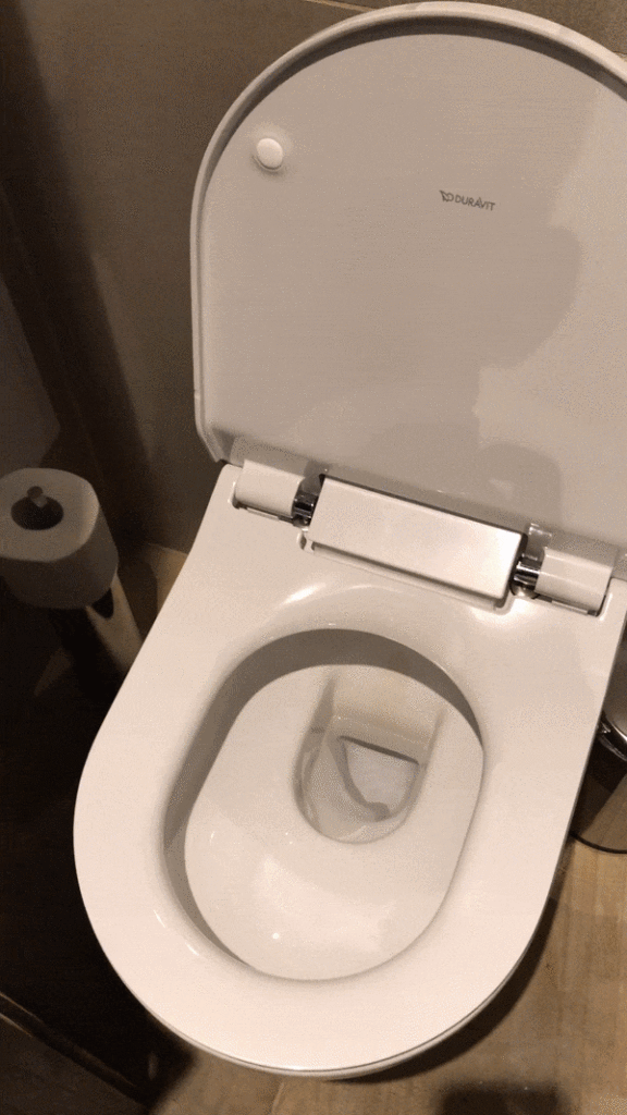 a toilet with a lid open