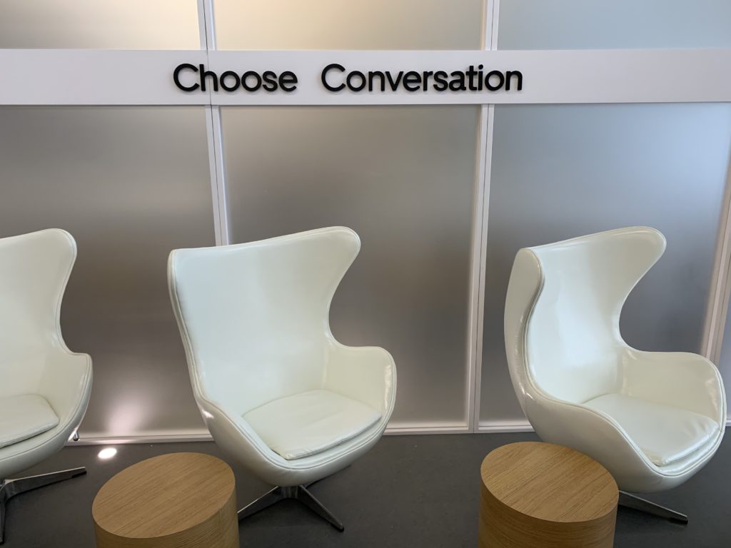 a group of white chairs in a room