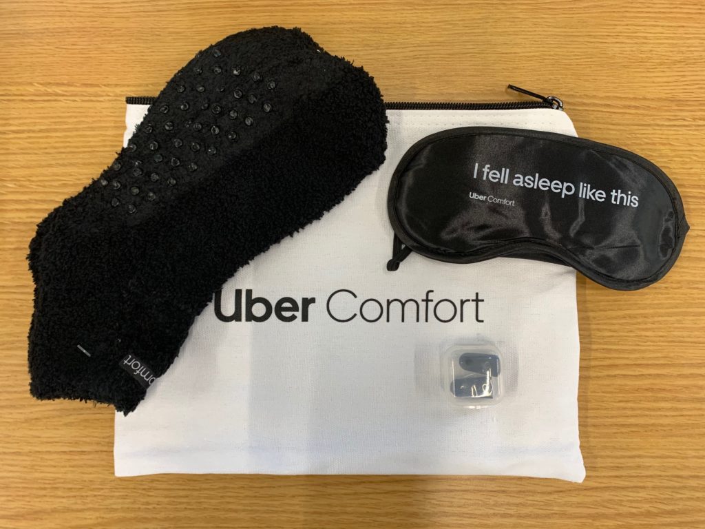 a black fuzzy object next to a black eye mask