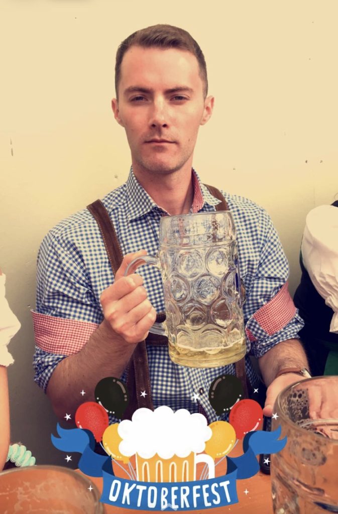a man holding a glass of beer