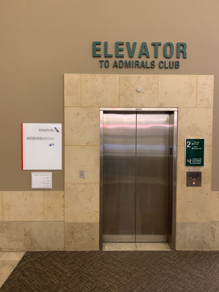 an elevator with a sign on the wall