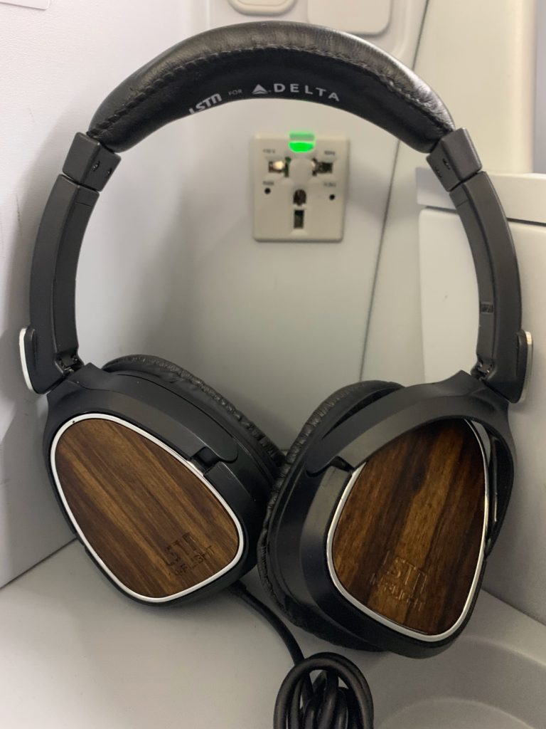 a pair of black headphones with wood grain on the side