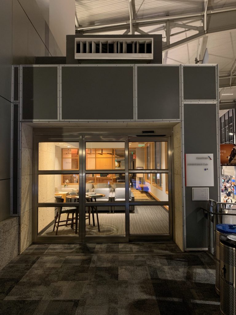 a glass door with a table and chairs in it