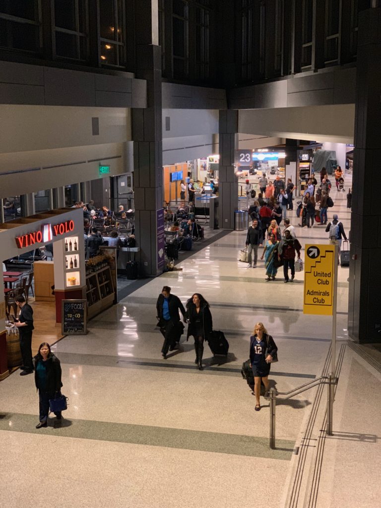 people walking in a large airport