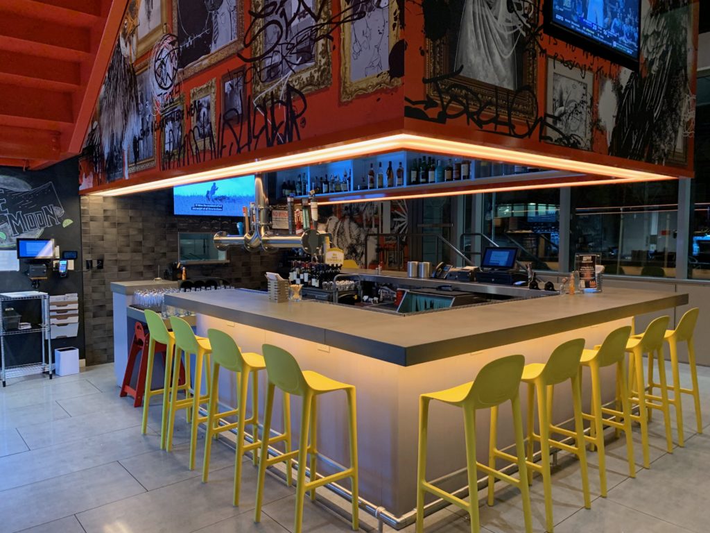 a bar with a counter and chairs