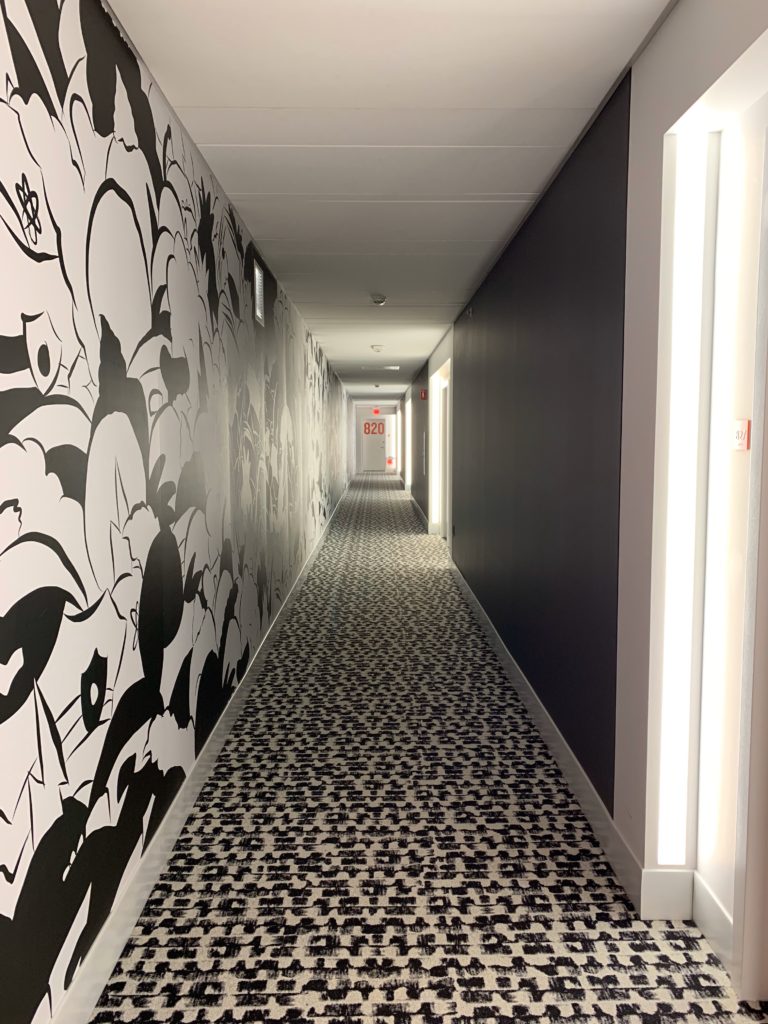 a hallway with a black and white wall