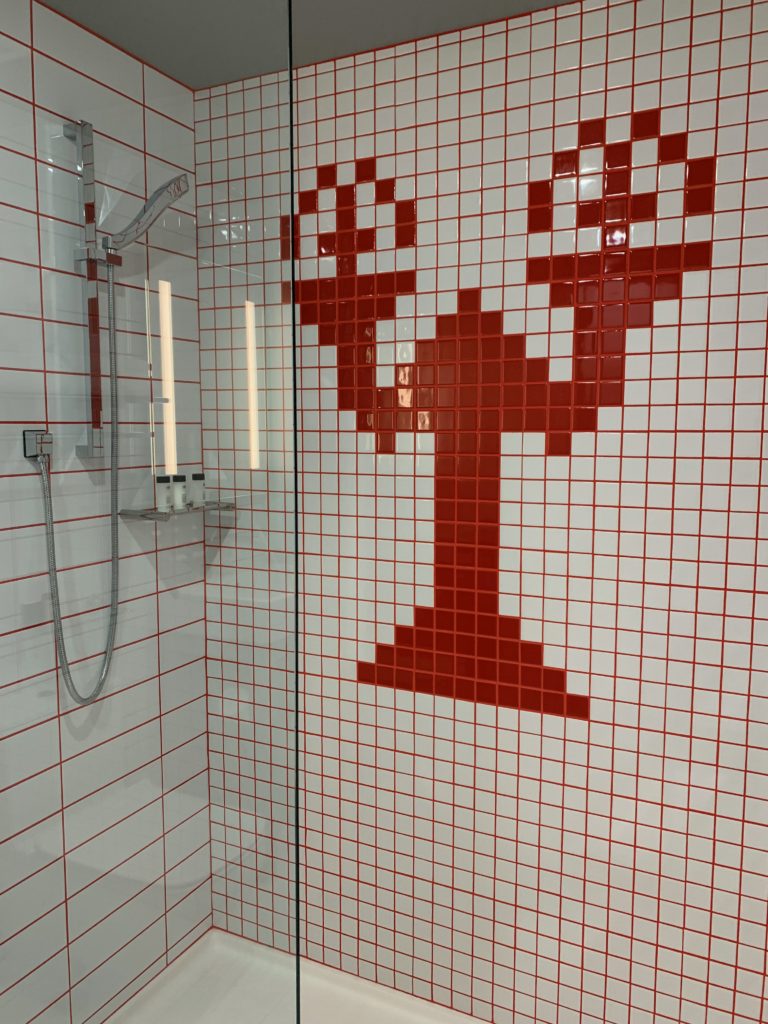 a shower with red tiles