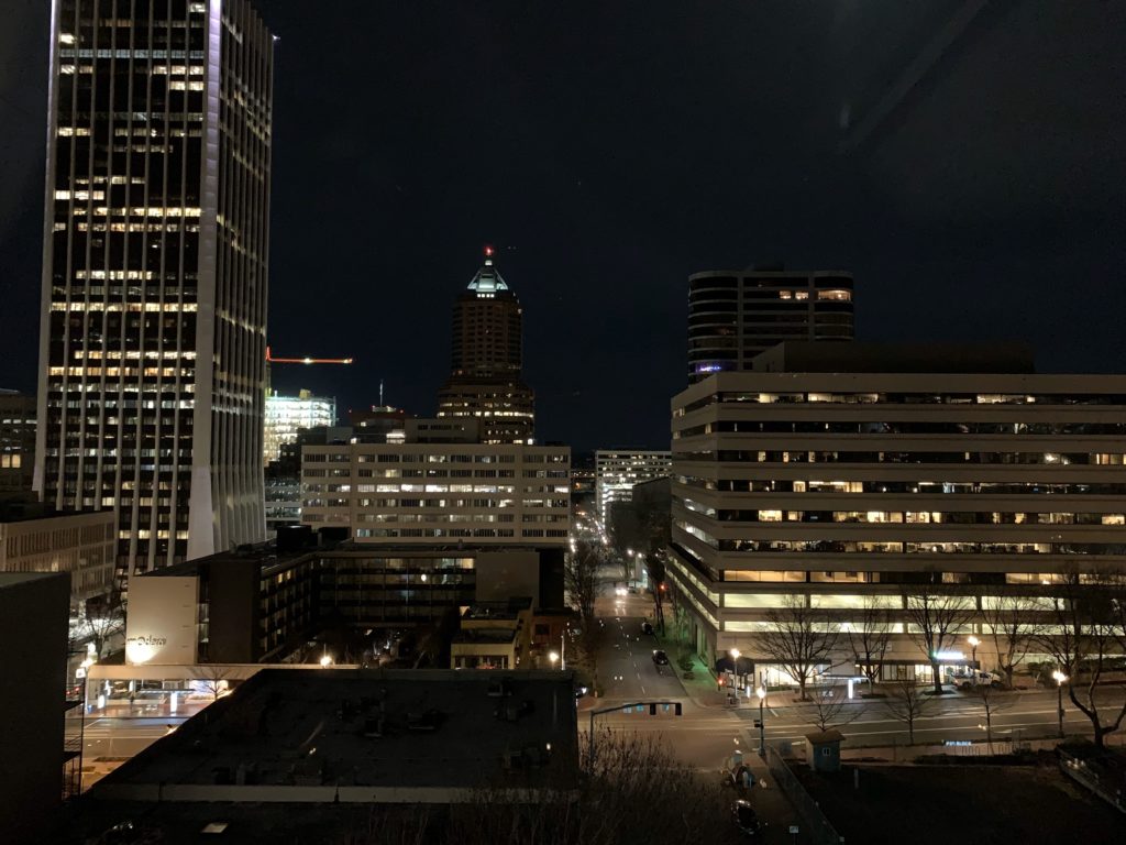 a city at night with buildings and a street