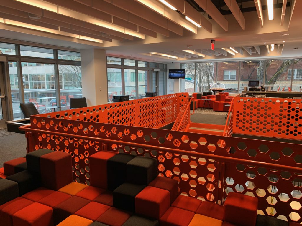 a room with orange walls and a red railing