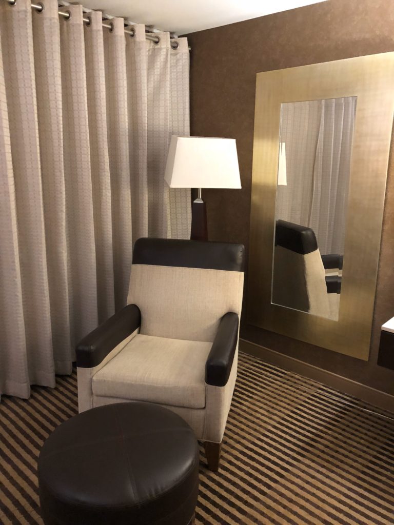 a chair and a mirror in a room