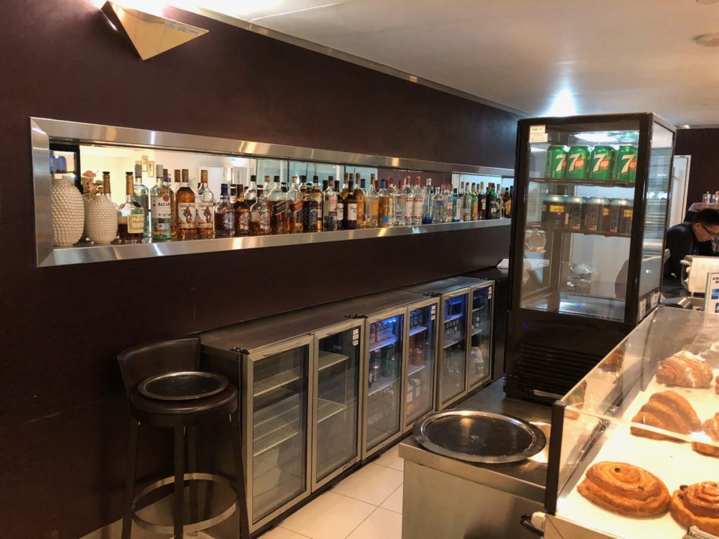 a bar with bottles of liquor and drinks