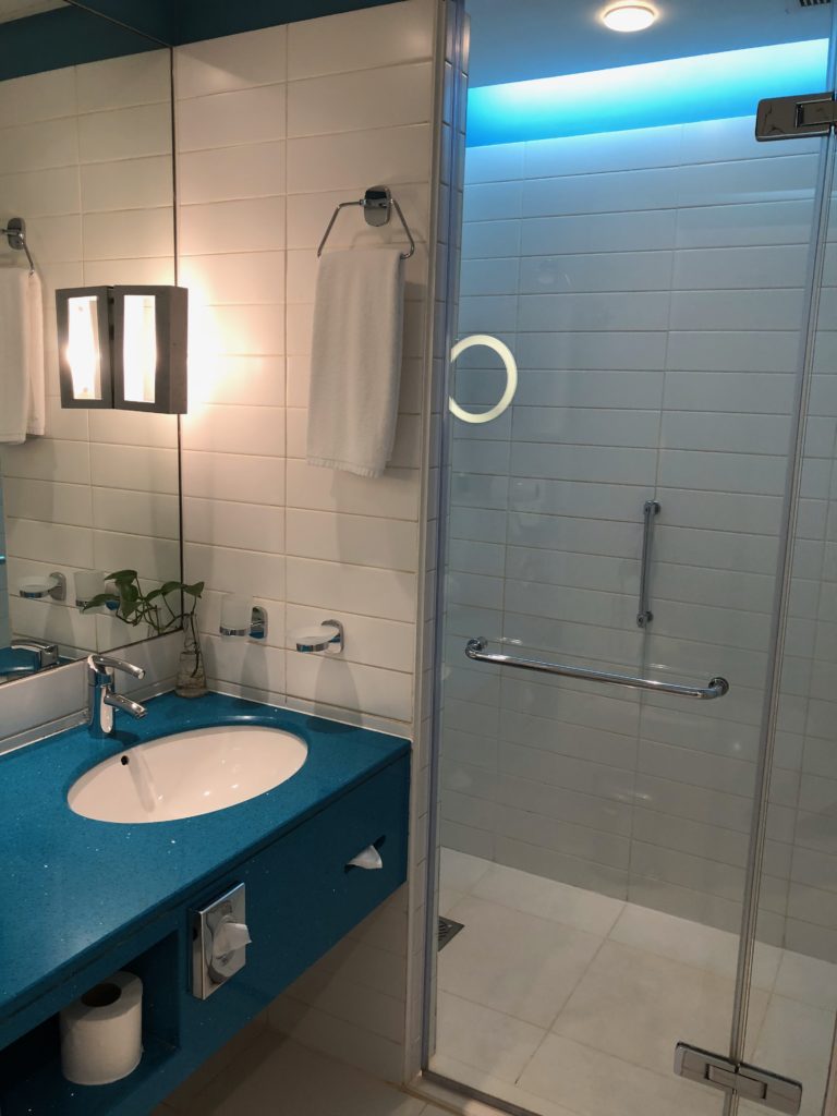 a bathroom with a glass shower door