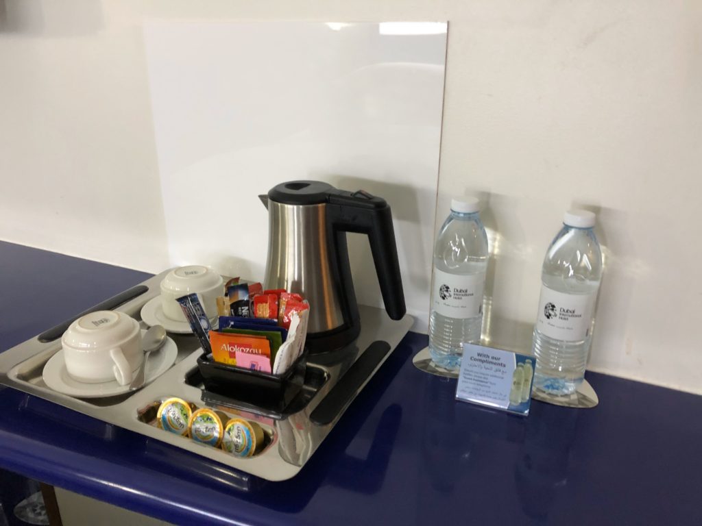 a tray with teapots and cups on a blue counter