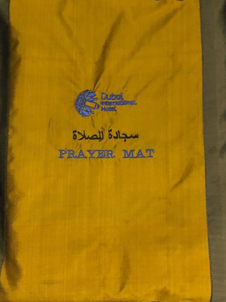 a yellow and grey prayer mat