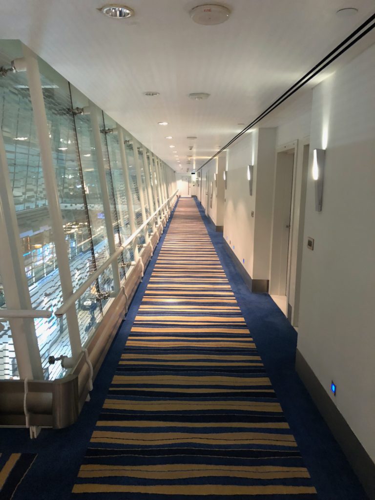 a long hallway with a striped carpet and a blue and yellow carpet