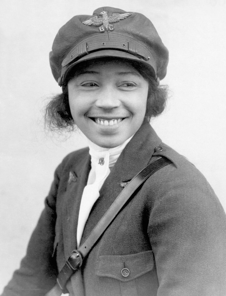 a woman wearing a hat and jacket