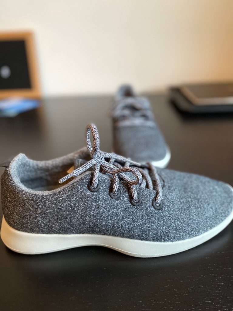 a pair of grey shoes on a table